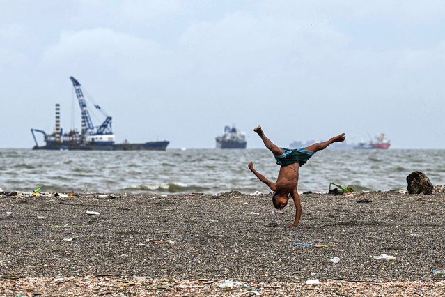 A child plays along Manila Bay on July 3, 2025. (Photo by Jam Sta Rosa/AFP Photo)