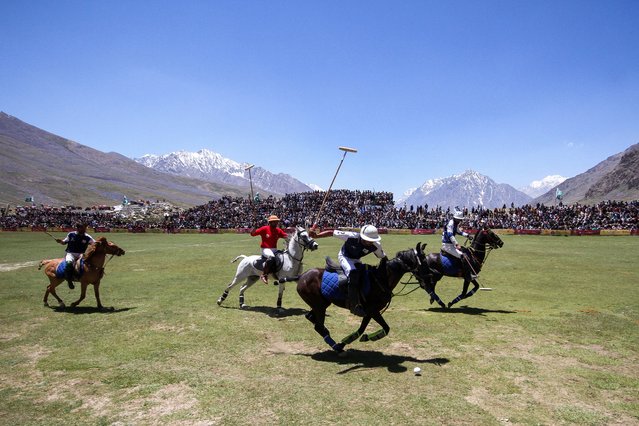Players (Gilgit-Baltistan in Blue and Chitral Laspur in Red) fight for the ball during the annual Shandur Polo Festival, at Shandur Pass, at an estimated altitude of around 3700 meters, in Chitral, Pakistan on June 20, 2025. (Photo by Khuram Parvez/Reuters)