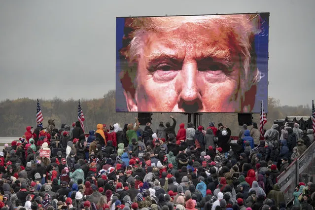Supporters of President Donald Trump watch a video during a campaign event on Tuesday, October 27, 2020, in Lansing, Mich. (Photo by Nicole Hester/Mlive.com/Ann Arbor News via AP Photo)