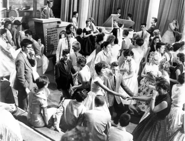 In a June 30, 1958, file photo, Dick Clark, at podium at upper left, is surrounded by teen-age fans on his nationally televised dance show “American Bandstand” in Philadelphia, Pa. TV was key to the world baby boomers were born into: a newly modernized world whose every problem (with the possible exception of the Cold War) seemed to promise an available solution. Polio would be cured! Man would go into space! Even African-Americans, oppressed for so long, had new reason for hope. TV chronicled this bracing wave of wonder and potential, and built upon it as an essential part of what distinguished boomers: They were pampered and privileged and ushered toward a sure-to-be-glorious future. (Photo by AP Photo)