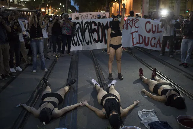 Demonstrators perform during a protest against the murder of councilwoman Marielle Franco in Rio de Janeiro, Brazil, Tuesday, March 20, 2018. Franco's murder came just a month after the government put the military in charge of security in Rio, which is experiencing a sharp spike in violence less than two years after hosting the 2016 Summer Olympics. (AP Photo/Leo Correa)