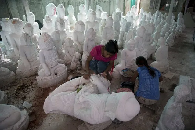 Women work on Buddha sculptures near Mahamuni Buddhist temple in Mandalay October 6, 2015. (Photo by Jorge Silva/Reuters)
