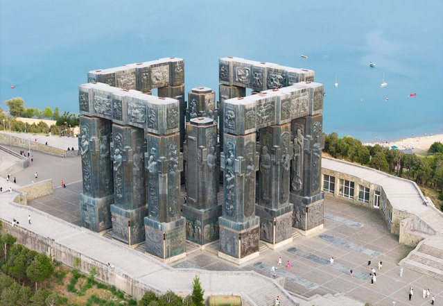 A view of the “Chronicle of Georgia”, located on Keeni Hill near the Tbilisi Sea in Georgia's capital Tbilisi on July 25, 2025. Construction of the monument, consisting of 16 massive columns, began in 1985 by renowned sculptor Zurab Tsereteli. The upper sections of the columns depict kings, queens, and national heroes from Georgian history. Adjacent to the monument stands a grapevine cross representing Saint Nino, who is believed to have introduced Christianity to Georgia, along with a small chapel. Positioned on a prominent northern hill overlooking the city, the site offers visitors an impressive panorama enriched with historical and religious symbolism. (Photo by Ahmet Aslan/Anadolu via Getty Images)