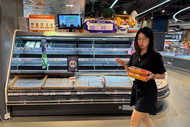 A customer walks past a nearly empty shelf at a supermarket, as Super Typhoon Ragasa approaches in Shenzhen, Guangdong province, China on September 23, 2025. (Photo by David Kirton/Reuters)