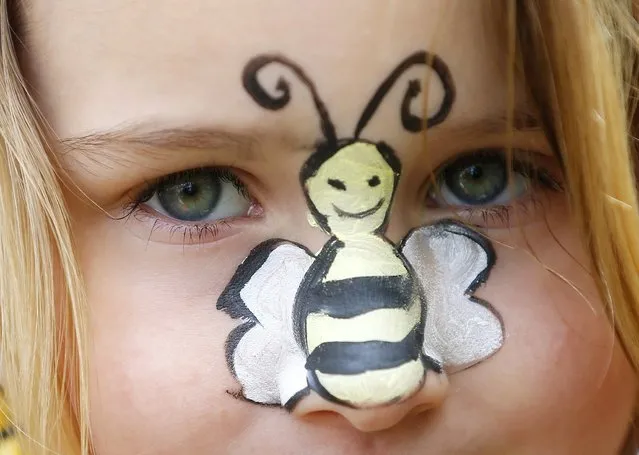 Amber, 5, sports a bee painted on her nose as she joins her mother at a protest in Parliament Square to urge Britain's government to ban the use of pesticides containing neonicotinoids, in central London, April 26, 2013. EU governments failed last month to agree a ban on three widely used pesticides linked to the decline of honeybees, but the European Commission is threatening to force such a ban through unless member states agree a compromise. (Photo by Andrew Winning/Reuters)