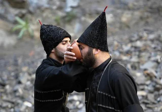 Georgian men dressed in old traditional clothes perform during celebrations of the Tbilisoba City Day in Tbilisi, Georgia, Saturday, October 15, 2016. (Photo by Shakh Aivazov/AP Photo)