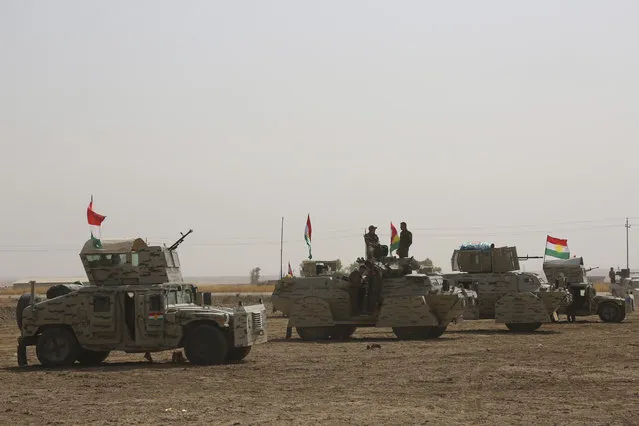 A peshmerga convoy drives towards a frontline in Khazer, about 30 kilometers (19 miles) east of Mosul, Iraq, Monday, October 17, 2016. (Photo by AP Photo)