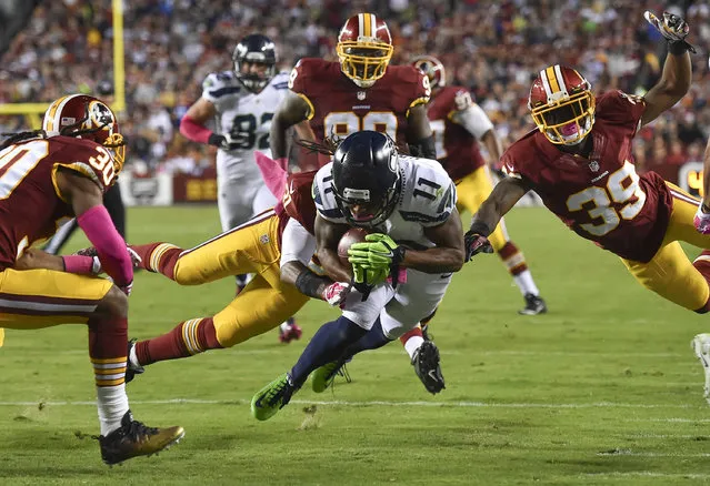 Seattle Seahawks wide receiver Percy Harvin (11) dives for a touchdown through Redskins defenders in the second quarter during a game between the Seattle Seahawks and the Washington Redskins at FedEx Field on October 6, 2014 in Landover, Md. The touchdown was called back for a penalty. (Photo by Ricky Carioti/The Washington Post)