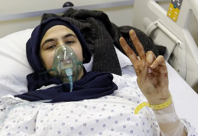 Lebanese youth Jannat, 12, who was wounded in a twin bombing attack that rocked a busy shopping street in the area of Burj al-Barajneh, a Beirut stronghold of Lebanon's Shiite movement Hezbollah, gestures at a hospital on November 13, 2015. Lebanon is mourning 43 people killed in the twin bombing claimed by the Islamic State group, the bloodiest such attack in years. (Photo by Anwar Amro/AFP Photo)