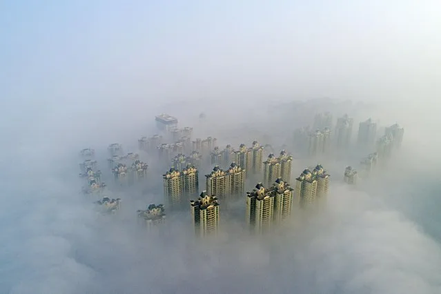 Aerial view of buildings shrouded in fog on December 10, 2020 in Xiangyang, Hubei Province of China. (Photo by Li Fuhua/VCG via Getty Images)