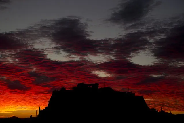 Red clouds are seen over the ancient Acropolis hill as the sun sets in the city of Athens, Tuesday, November 3, 2015. (Photo by Petros Giannakouris/AP Photo)
