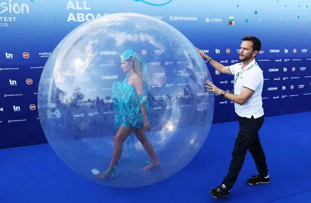 An assistant helps an actress walking in a plastic ball before the opening party for the Eurovision Song Contest at the Maat museum in Lisbon, Portugal May 6, 2018. (Photo by Vyacheslav Prokofyev/TASS)