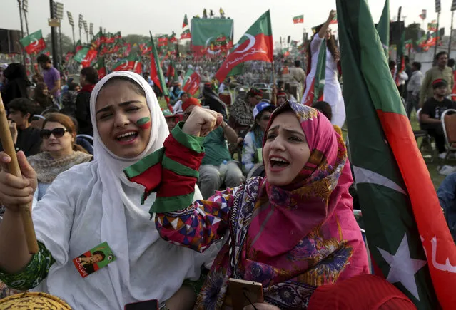 Supporters of opposition leader Imran Khan's party Tehreek-e-Insaf chant slogans during a rally in Lahore, Pakistan on April 29, 2018. Tens of thousands of supporters of a popular opposition lawmaker who hopes to become Pakistan's prime minister have gathered in the eastern city of Lahore as his political party launched its campaign for July elections. (Photo by K.M. Chaudary/AP Photo)