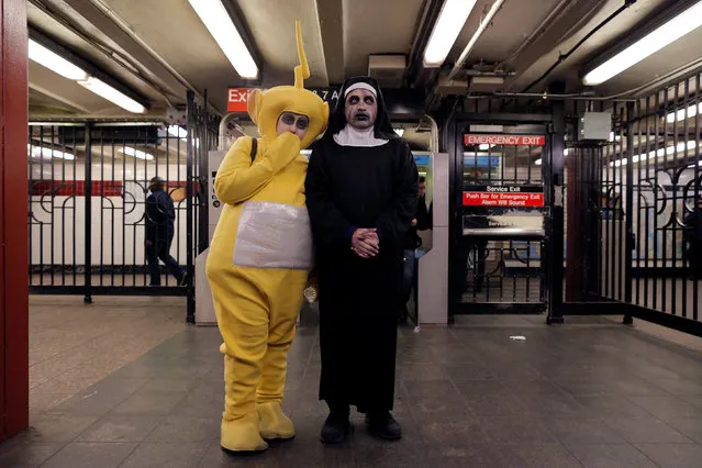 People in costume await the subway on Halloween in Manhattan, New York, U.S., October 31, 2016. (Photo by Andrew Kelly/Reuters)