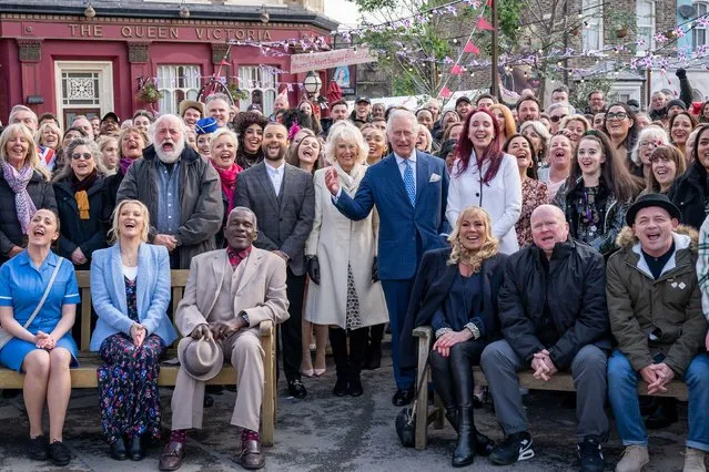 Britain's Prince Charles and Camilla, Duchess of Cornwall pose for a group photo with the cast and crew during a visit to the set of EastEnders at the BBC studios in Elstree, Hertfordshire, Britain on March 31, 2022. (Photo by Aaron Chown/Pool via Reuters)