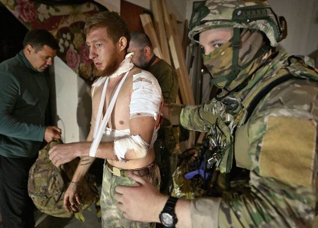 Medics help a local resident in a field hospital at an undisclosed location in the Kursk region on August 11, 2024. Ukraine controlled at least 800 square kilometres (308 square miles) of Russian territory in the Kursk region as of August 12, 2024, according to an AFP analysis of data provided by the Institute for the Study of War. Kyiv launched a surprise offensive into Russia's western Kursk region on August 6, capturing over two dozen settlements in the most significant cross-border attack on Russian soil since World War II. (Photo by Anatoliy Zhdanov/Kommersant Photo via AFP Photo)