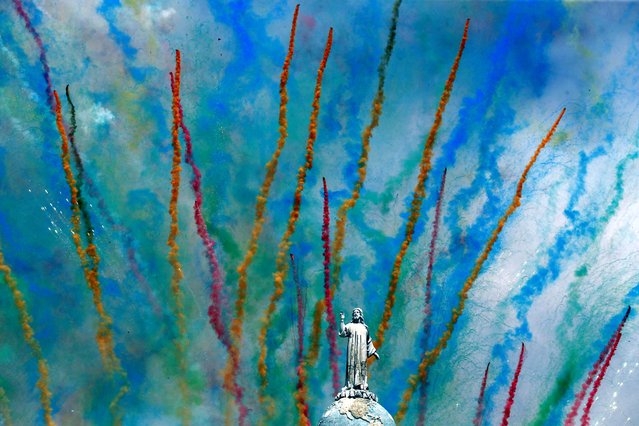 Fireworks are seen behind the monument of El Salvador del Mundo during the opening parade of the festivities of El Divino Salvador del Mundo (The Divine Savior of The World), patron saint of the capital city of San Salvador, El Salvador, on August 1, 2024. (Photo by Jose Cabezas/Reuters)