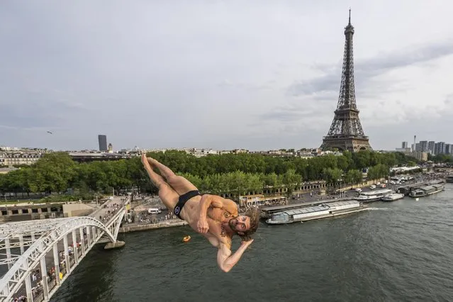 In this handout image provided by Red Bull, David Colturi of the United States dives from the 27.5 metre platform during the first competition day of the second stop of the Red Bull Cliff Diving World Series on June 17, 2023 at Paris, France. (Photo by Romina Amato/Red Bull via Getty Images)