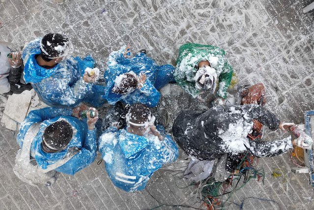 People covered in soap foam take part in a parade during the “Blacks and Whites” carnival in Pasto, Colombia on January 4, 2025. The Blacks and Whites carnival has its origins in a mix of Andean, Amazonian and Pacific cultural expressions, and it celebrates the ethnic diversity in the region and was proclaimed by UNESCO as intangible cultural heritage in 2009. (Photo by Raul Arboleda/AFP Photo)