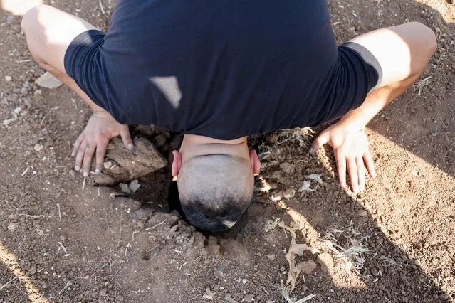 A man investigates the scene where three Palestinian gunmen were killed by an Israeli drone strike on Wednesday, near Jenin, in the Israeli-occupied West Bank on June 22, 2023. (Photo by Raneen Sawafta/Reuters)
