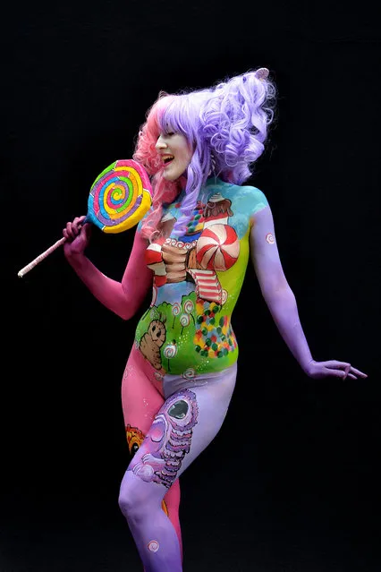 A participant poses with her body paintings designed by bodypainting artist Constanze Ryniak during the 16th World Bodypainting Festival in Poertschach on July 6, 2013 in Poertschach am Woerthersee, Austria. (Photo by Didier Messens/Getty Images)