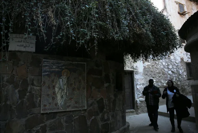 People walk in front of the tree which Moses was believed to have slept under, before he met God, inside Saint Catherine's monastery, in the Sinai Peninsula, south of Egypt, December 8, 2015. (Photo by Amr Abdallah Dalsh/Reuters)