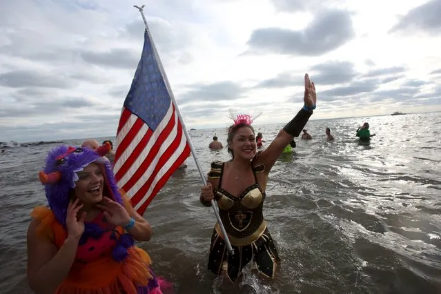 A woman waves a U.S. flag during the Coney Island Polar Bear Club's annual New Year's Day swim at Coney Island in the Brooklyn borough of New York January 1, 2016. (Photo by Andrew Kelly/Reuters)
