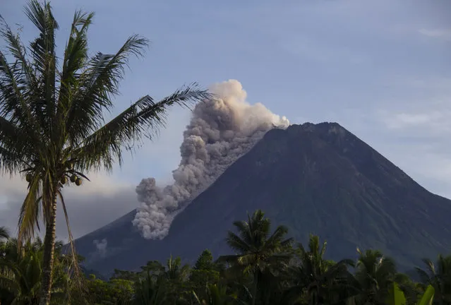 Mount Merapi releases volcanic materials down its slope during an eruption in Sleman, Indonesia, Saturday, March 27, 2021. Indonesia's most volatile volcano was erupting again Saturday, releasing plumes of ash high into the air and sending streams of lava and debris down its slopes. No casualties were reported. (Photo by Slamet Riyadi/AP Photo)