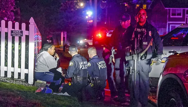 Police stand by a distraught Kristi Croskey at the scene where a Tacoma Police officer was shot while responding to a domestic call in East Tacoma, Wash., Wednesday, November 30, 2016. Croskey was in the house with the shooter and fled. KCPQ-TV reports an officer was taken to a Tacoma hospital Wednesday after the incident at about 5:30 p.m. (Photo by Peter Haley/The News Tribune via AP Photo)