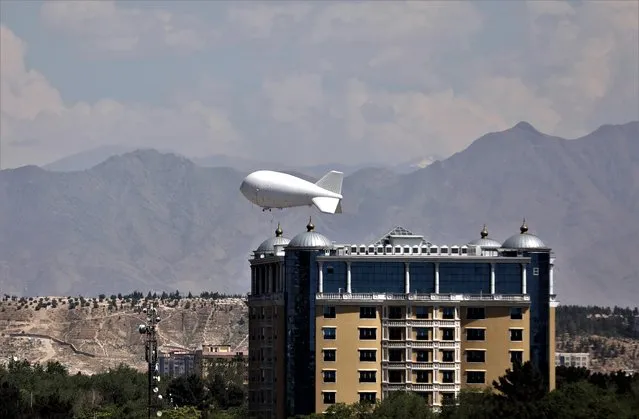 A security surveillance balloon flies over Kabul, Afghanistan, Wednesday, May 19, 2021. (Photo by Rahmat Gul/AP Photo)