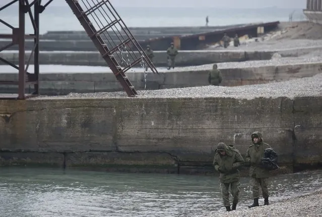 Russian servicemen stand at the shores of the Black Sea near the crash site of a Russian military Tu-154 plane, in the Sochi suburb of Khosta, Russia December 25, 2016. (Photo by Maxim Shemetov/Reuters)