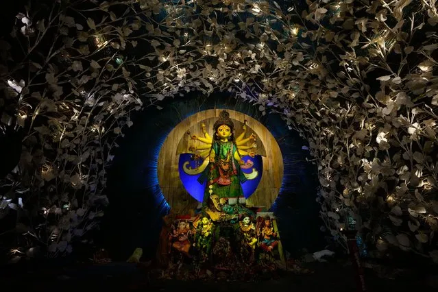 An idol of Hindu goddess Durga installed at a temporary worship venue is seen in the early hours of the final day of Durga Puja festival in Kolkata, India, Tuesday, October 24, 2023. The festival will end with the immersion of the Durga idols in water bodies later in the day. (Photo by Bikas Das/AP Photo)