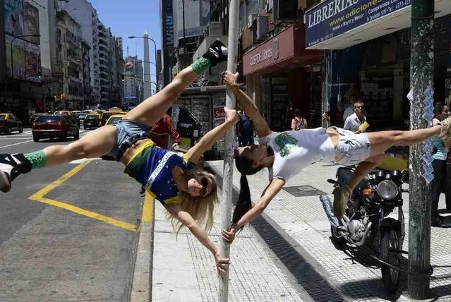 Participants in the Miss Pole Dance South America 2013 competition perform in downtown Buenos Aires on November 22, 2013 ahead of the contest to be held on November 23 and 25 in the city. (Photo by Juan Mabromata/AFP Photo)