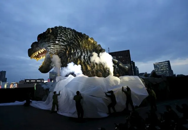 A real-scale head of Godzilla is unveiled at the balcony of a newly-built commercial complex as a new Tokyo landmark at Kabukicho shopping and amusement district in Tokyo April 9, 2015. (Photo by Issei Kato/Reuters)