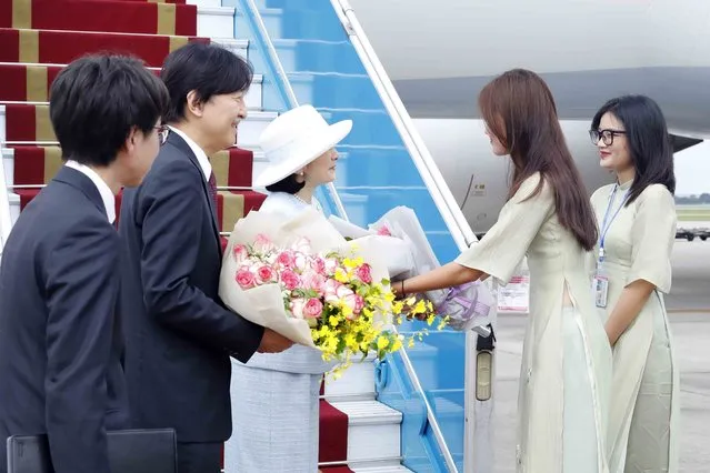 Japanese Crown Prince Akishino, second left, and Crown Princess Kiko, third left, receive flowers from Vietnamese officials after landing in Hanoi, Vietnam Wednesday, September 20, 2023. They are on a visit to Vietnam to mark the 50th anniversary of the diplomatic relation between the two countries. (Photo by An Van Dang/VNA via AP Photo)