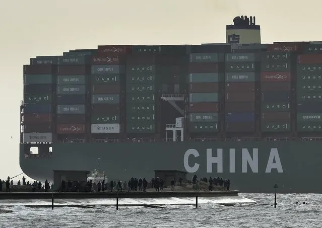 Onlookers watch from a harbour wall as the largest container ship in world, CSCL Globe, docks during its maiden voyage, at the port of Felixstowe in south east England, in this January 7, 2015 file photo. China is expected to releas exports, imports and trade surplus for March this week. (Photo by Toby Melville/Reuters)