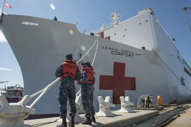 Boatswain's Mate 3rd Class Taryn Armington and Sonar Technician (Surface) Seaman Darian Joseph prepare to cast off mooring lines for the Military Sealift Command hospital ship USNS Comfort (T-AH 20) as the ship departs Naval Station Norfolk to support hurricane relief efforts in Puerto Rico  Friday, September 29, 2017 in Norfolk, Va.. The Department of Defense is supporting the Federal Emergency Management Agency, the lead federal agency, in helping those affected by Hurricane Maria to minimize suffering and is one component of the overall whole-of-government response effort. (Photo by MC3 Brittany Tobin/U.S. Navy via AP Photo)