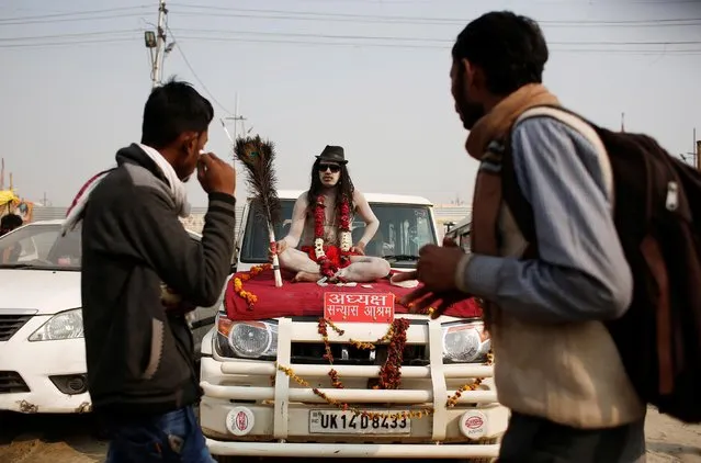 A Naga Sadhu or Hindu holy man sits on a car as he waits for devotees during “Kumbh Mela” or the Pitcher Festival, in Prayagraj, previously known as Allahabad, India, February 2, 2019. (Photo by Adnan Abidi/Reuters)