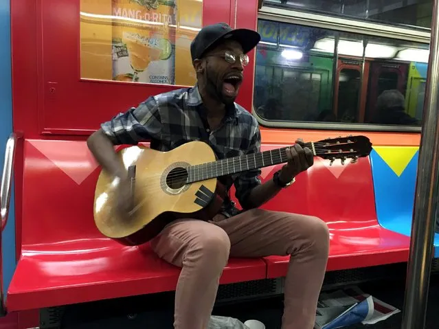 A man performs a song on the shuttle subway in Times Square in the Manhattan borough of New York, February 19, 2016. (Photo by Carlo Allegri/Reuters)