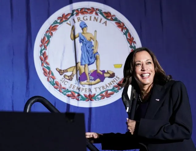 U.S. Vice President Kamala Harris takes the stage with the Virginia State flag in the background during a campaign rally for Virginia Democratic gubernatorial candidate Terry McAuliffe in Dumfries, Virginia on October 21, 2021. (Photo by Kevin Lamarque/Reuters)