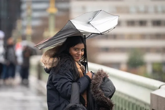 A person's umbrella is damaged during heavy rain on Westminster Bridge on Tuesday, January 2, 2024. The Met Office has issued an amber weather warning for Storm Henk, which is forecast to bring gusts of up to 80mph to parts of the UK. (Photo by Stefan Rousseau/PA Wire)