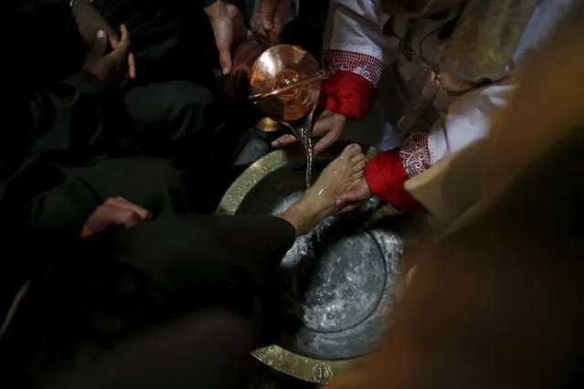 Latin Patriarch of Jerusalem Fouad Twal washes the foot of a priest during the Catholic Washing of the Feet ceremony in the Church of the Holy Sepulchre in Jerusalem's Old City during Holy Week March 24, 2016. (Photo by Ammar Awad/Reuters)