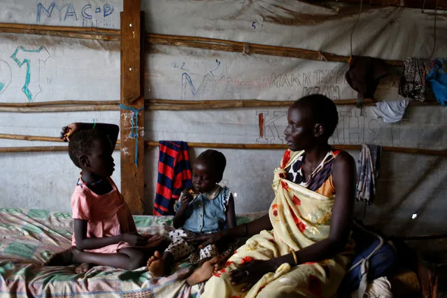 Nyagonga Machul, 38 converses with her daughters Nyameer Mario, 6 (L) and  Nyawan Mario, 4, in their home at the United Nations Mission in South Sudan (UNMISS) Protection of Civilian site (CoP) in Juba, South Sudan, February 15, 2017. (Photo by Siegfried Modola/Reuters)
