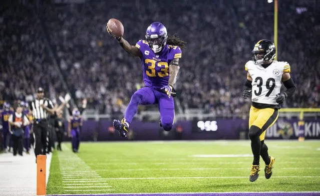 Minnesota Vikings running back Dalvin Cook (33) jumps into the end zone near Pittsburgh Steelers free safety Minkah Fitzpatrick (39) for a touchdown run in the second quarter of an NFL football game in Minneapolis, Thursday, December 9, 2021. (Photo by Jerry Holt/Star Tribune via AP Photo)