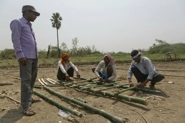 Nepalese men make bamboo stretchers to carry dead victims of a rainstorm in Bara district in Birgunj, 125 kilometers (75 miles) from Kathmandu, Nepal, Monday, April 1, 2019. Villagers who survived a powerful rainstorm that killed at least 28 people and injured hundreds in southern Nepal searched for food and shelter Monday as rescuers struggled to reach remote areas. (Photo by Niranjan Shrestha/AP Photo)
