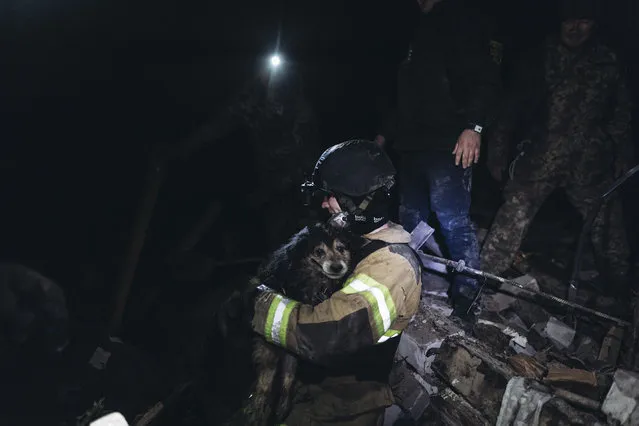 Emergency service workers rescue a dog from the rubble of a house after shelling in Chasiv Yar, as Russia-Ukraine war continues on January 18, 2023. (Photo by Diego Herrera Carcedo/Anadolu Agency via Getty Images)