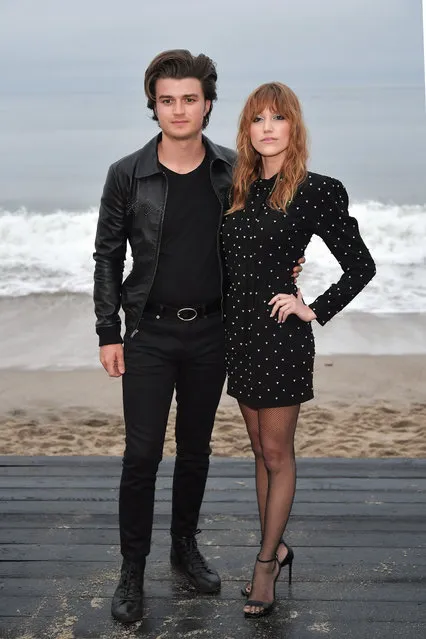 (L-R) Joe Keery and Maika Monroe attend the Saint Laurent Mens Spring Summer 20 Show on June 06, 2019 in Paradise Cove Malibu, California. (Photo by Neilson Barnard/Getty Images)