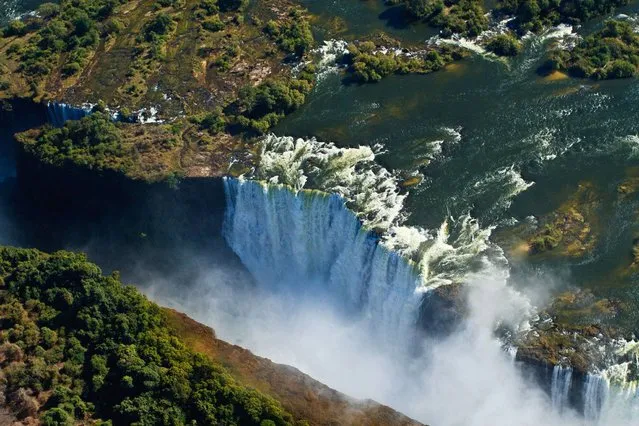 Victoria Falls (Zimbabwe/Zambia). Explorer David Livingstone named the waterfalls of the Zambezi River after Queen Victoria, but locals call them Mosi-oa-Tunya, meaning ‘the smoke that thunders’. Located on the border between Zimbabwe and Zambia, the falls plummet 108m, creating a mist that is visible from 20km away. The falls were formed some 200-150 million years ago, during the Jurassic or Upper Karoo Period when land masses forming South America, African, India, Australasia and Antarctica were one huge super-continent known as Gondwanaland. (Photo by Kelly Cheng Travel Photography/Getty Images)