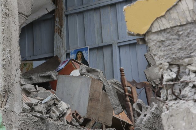 A destroyed house is seen in Pedernales, Ecuador, Sunday, April 17, 2016. A magnitude-7.8 quake, the strongest since 1979, hit Ecuador flattening buildings, buckling highways along its Pacific coast and killing hundreds. (Photo by Dolores Ochoa/AP Photo)