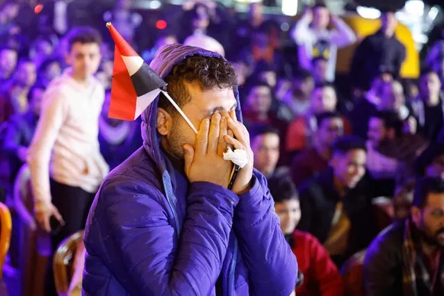 A supporter of the Egypt national football team reacts as he watches the African Cup of Nations 2022 final match between Egypt and Senegal at a coffee shop in Cairo on February 6, 2022. (Photo by Khaled Desouki/AFP Photo)